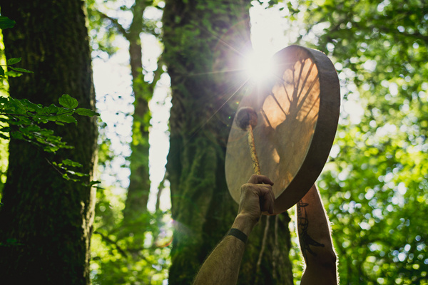 Adult man playing shamanic drum